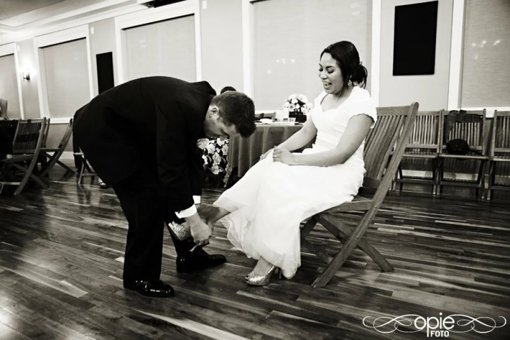 Image of groom taking garter off