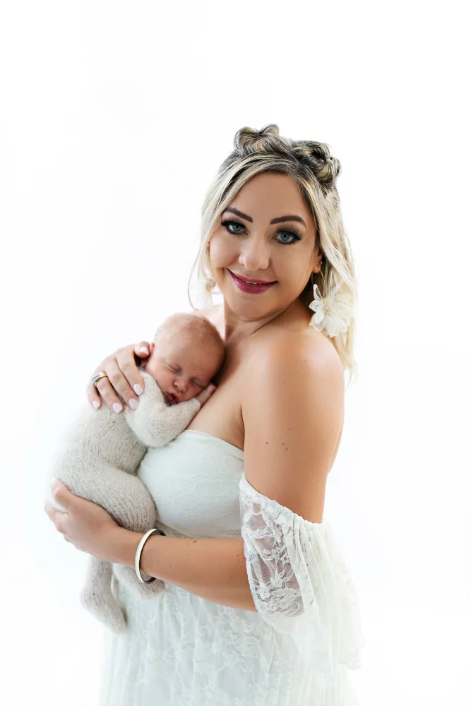 Image of mom holding newborn baby boy in her arms